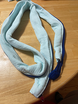 A long, narrow length of cloth to cover tubing.